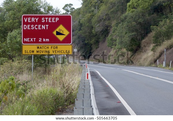 Very steep descent sign indicating a 12%\
decline and warning about slow moving\
vehicles.