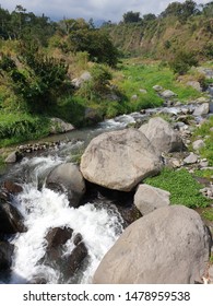 A Very Swift River In A Green Valley. This River Is Located In The Wonolelo Magelang Area Of ​​Central Java. Very Beautiful Scenery.