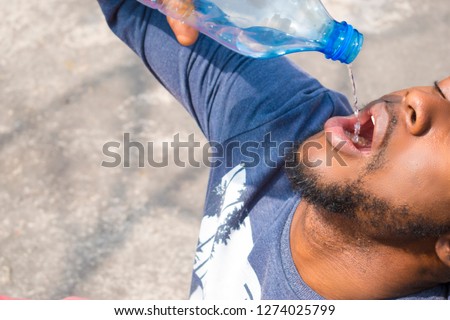 Similar – Image, Stock Photo A very thirsty black dog greedily drinks water from a hose on a hot summer day