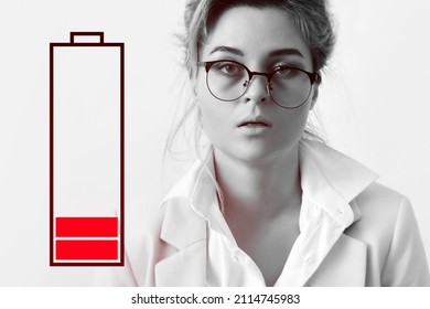 Very tired businesswoman and low battery symbol. Concepts of job burnout, overwork and stress. - Powered by Shutterstock