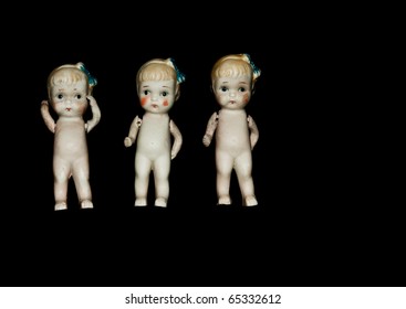 Very vintage ceramic dolls with articulating shoulder joints, black isolation.