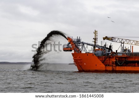 Vessel engaged in dredging. Dredger working at sea. Ship excavating material from a water environment.