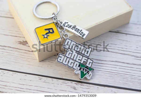 Vestfold, Norway - September, 27, 2019: Keyring\
GTA 5 on wooden background. Grand Theft Auto (GTA) is a series of\
computer games and video\
games.