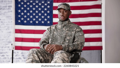 Veteran Sitting In Wheelchair In Front Of An American Flag - Powered by Shutterstock