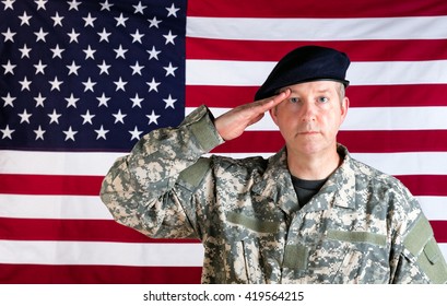 Veteran Soldier, Facing Forward, Saluting With USA Flag In Background.