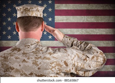 VETERAN SOLDIER | Marine in Desert Fatigues Saluting an American Flag - Powered by Shutterstock