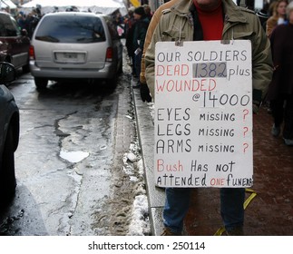 Veteran Soldier Protesting W/ Sign @ Inauguration Of George W Bush. # Of Dead And Wounded On Sign.