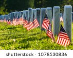 Veterans Cemetary with rows of tombstones and flags