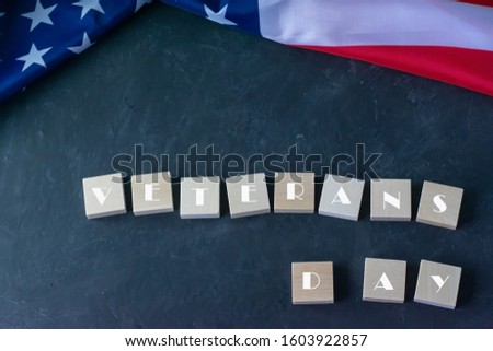 Veterans Day. American flag and the inscription on a black background
