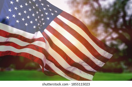 Veterans Day Flag Of The United States Of America. American flag flying on the background of the setting sun in nature. - Shutterstock ID 1855115023