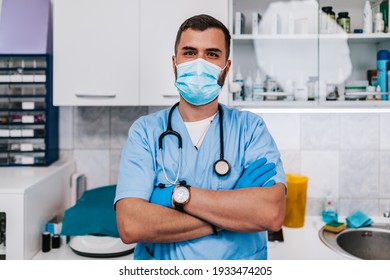 Veterinarian Doctor With Face Protective Mask Posing And Looking At Camera At Vet Ambulance.