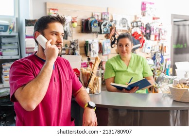 Veterinary clinic staff and pet shop, answering a client by phone and scheduling a date for consultation. people in the workplace.