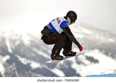 VEYSONNAZ, SWITZERLAND - JANUARY 22: Finalist Tony Ramoin (FRA) on a jump at the FIS World Championship Snowboard Cross finals : January 22, 2012 in Veysonnaz Switzerland