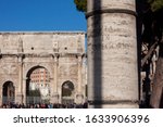 Via di San Gregorio street on a classic column at the roman forum close to the Colosseum and the Constatine arch in the foreground