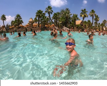 Via Michelangelo Buonarroti, Lido Di Jesolo, Venezia, ITALY - July 12, 2019 SHARK BAY. CARIBE BAY Is WATER THEME PARK. Boy Have Fun And Swim In Pool. Water Park With Wave Pool. Waterpark. Aquapark