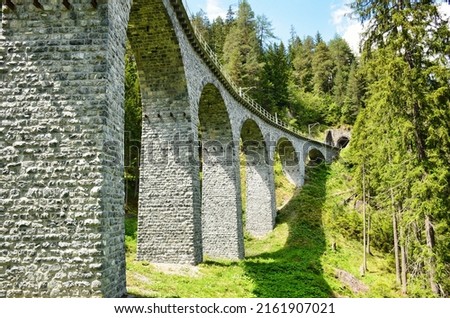 viaduct in the landwasser valley between davos and filisur. old stone viadukt from a railway. Wiesn in Graubunden.