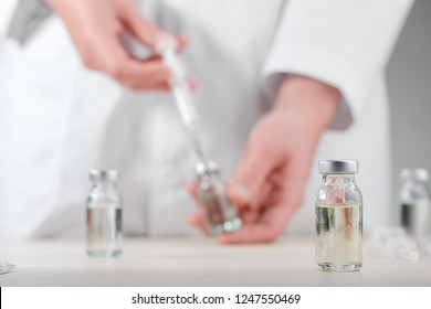 Vial On A Desk In A Laboratory, Selective Focus. New Vaccine Development, Science, Medicine And The Future.