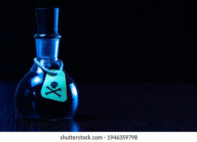 Vial Of Poison With A Hazard Warning Label, On A Dark Background, Toning, Short Focus 