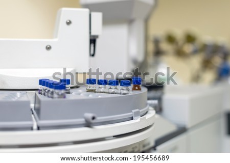 Vials in the autosampler of gas chromatography-mass spectrophotometer tray. Development of a new vaccine against the covid-19 virus. Focus on the center vials Stock photo © 