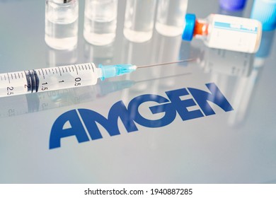 Vials of liquid on a white table and the logo Amgen, large pharmaceutical company. March 15, 2021. Barnaul, Russia.