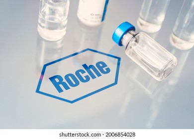 Vials of liquid on a white table and the logo of a large pharmaceutical company Roche. March 15, 2021. Barnaul, Russia.