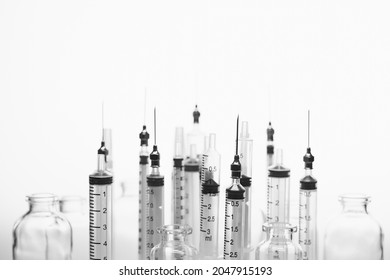 Vials Of Medicine And Silhouette Plastic Syringe With Needle In Black And White Image. Needle Phobia.