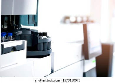 Vials (small bottle) in tray inside injection section of Gas Chromatography (GC) instrument, chemistry analytical experiment concept