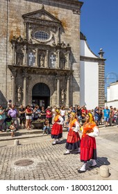 Viana Do Castelo, Portugal - August 21, 2015: Stewardship Parade, With Three Mordomas Parading Before The Public During The Pilgrimage Of Nossa Senhora Da Agonia. Church Of São Domingos In Background.