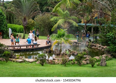 VIANOPOLIS - BETIM, MINAS GERAIS / BRAZIL - JAN 2, 2016: Visitors enjoying the beauty of the small and green square with a decorated laggon in the middle of Vale Verde - Alembic and Ecological Park.