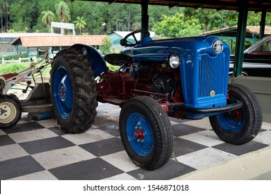 VIANOPOLIS - BETIM, MINAS GERAIS / BRAZIL - JAN 2, 2016: A restored 50's blue Ford 600 series (AKA Ford NAA) vintage tractor parked in a shed in the middle of Vale Verde - Alembic and Ecological Park.