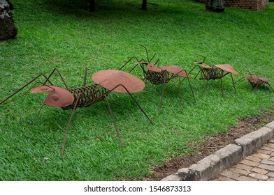 VIANOPOLIS - BETIM, MINAS GERAIS / BRAZIL - JANUARY 2, 2016: A row of giant ants made of metal scrap displayed as decoration on a grass field inside Vale Verde - Alembic and Ecological Park.