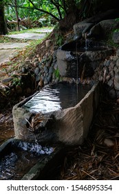 VIANOPOLIS - BETIM, MINAS GERAIS / BRAZIL - JAN 2, 2016: A fountain with crystal clear water flowing from higher to lower basin in the middle of a garden in Vale Verde - Alembic and Ecological Park.