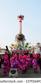 VIAREGGIO, ITALY - MARCH 4, 2012: Festive procession during the renowned Viareggio carnival parade. Spectacular floats depicting caricatures of popular politicians, celebrities or current events.