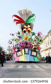 VIAREGGIO, ITALY - MARCH 4, 2012: Festive procession during the renowned Viareggio carnival parade. Spectacular floats depicting caricatures of popular politicians, celebrities or current events.