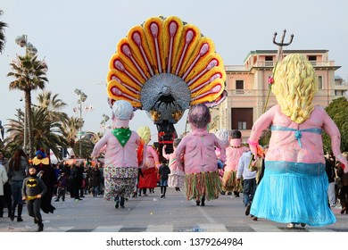 VIAREGGIO, ITALY - MARCH 4, 2012: Festive procession during the renowned Viareggio carnival parade. Spectacular floats depicting caricatures of popular politicians, celebrities or current events.
