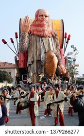 VIAREGGIO, ITALY - MARCH 4, 2012: Festive procession during the renowned Viareggio carnival parade. Spectacular floats depicting caricatures of popular politicians, celebrities or current events.