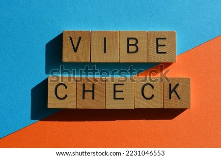 Vibe Check, Get Z buzzword meaning an evaluation of someones emotional state in wooden alphabet letters isolated on bright background