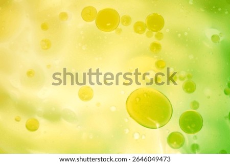 A vibrant abstract background featuring floating bubbles in shades of green and yellow. The fluid design creates a lively and modern aesthetic perfect for creative projects.