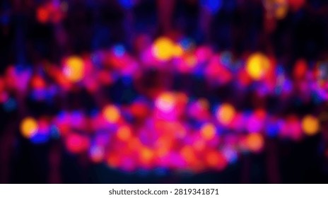 A vibrant abstract background featuring out of focus bokeh lights in shades of red, purple, and yellow, creating a festive and energetic atmosphere.