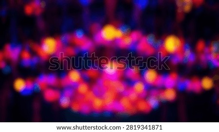 A vibrant abstract background featuring out of focus bokeh lights in shades of red, purple, and yellow, creating a festive and energetic atmosphere.