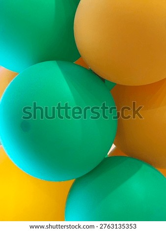 a vibrant abstract background featuring overlapping green and yallow balloon with soft natural lighting the composition creates a clean modern and minimal aesthetic perfect for use in celebrations  party themes branding advertising or festive designs the smooth textures and bright color contrast offer a fresh and cheeful visual suitable  for booth digital and print projects 