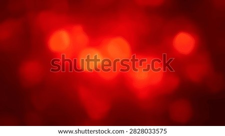 Vibrant abstract background featuring soft red bokeh lights with a gentle glow and shallow depth of field.