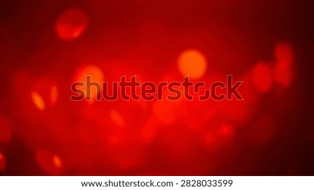 A vibrant abstract background featuring soft red bokeh lights with a warm glow and gentle focus, perfect for festive or energetic designs.