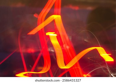 Vibrant abstract light trails in red, creating dynamic motion and energy with swirling lines and glowing streaks against a dark background
