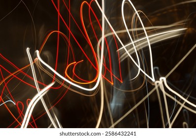 Vibrant abstract light trails in red and white, creating dynamic motion and energy with swirling lines and glowing streaks against a dark background.