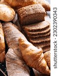  vibrant and appetizing captures a variety of baked goods created by the skilled hands of bakers. Gorgeous bread rolls, perfectly golden croissants, fresh and fragrant baguettes are present