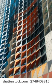 Vibrant architectural pattern featuring multi-colored geometric sunshades on a contemporary building exterior.