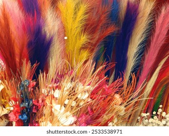 A vibrant arrangement of colorful dried flowers and grasses creating a lively and textured display. - Powered by Shutterstock