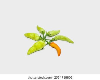 A vibrant arrangement of green and orange chili peppers on a clean white background, showcasing their contrasting colors and fresh appearance. Ideal for food-related visuals and culinary themes. - Powered by Shutterstock