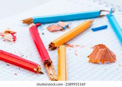 A Vibrant Array of Colored Pencils Creating Artistic Magic on Paper. A group of colored pencils sitting on top of a piece of paper
